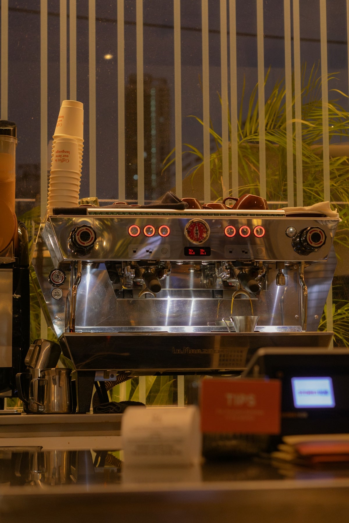 A shiny espresso machine is ready to brew.