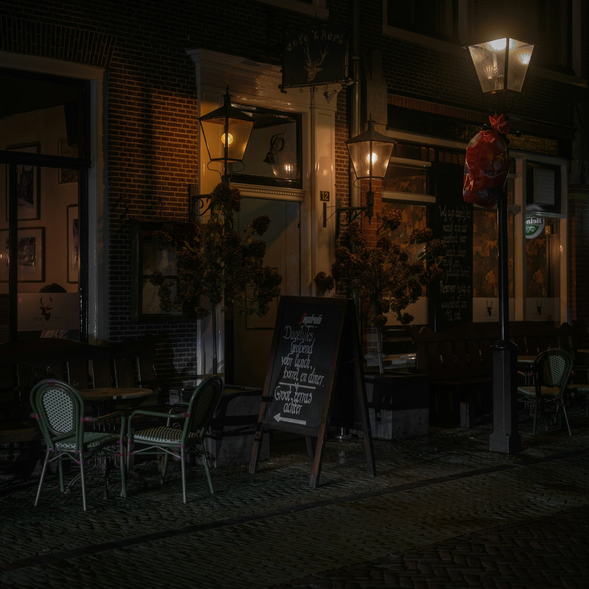 Outdoor cafe seating at night with warm lighting