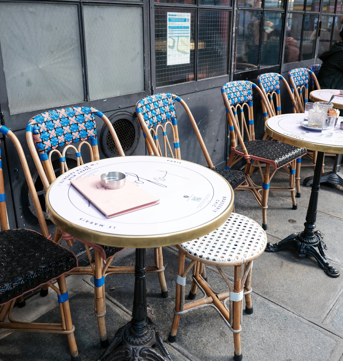 Outdoor cafe tables and chairs on a sidewalk